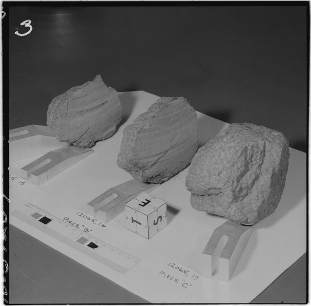 Black and white photograph of Apollo 12 Sample(S) 12065,15-17; Processing photograph displaying a slab reconstruction sample with an orientation of E,S,T.