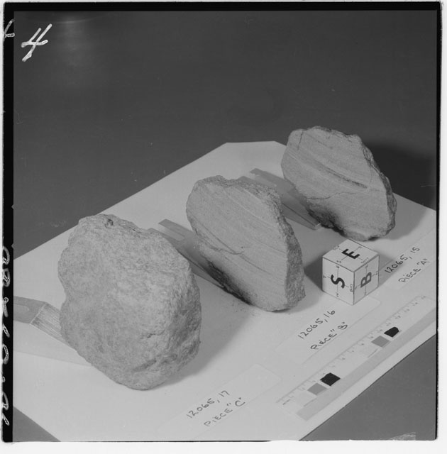 Black and white photograph of Apollo 12 Sample(S) 12065,15-17; Processing photograph displaying a slab reconstruction sample with an orientation of S,E,B.