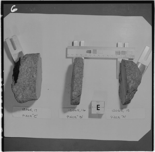 Black and white photograph of Apollo 12 Sample(S) 12065,15-17; Processing photograph displaying a slab reconstruction sample with an orientation of E .