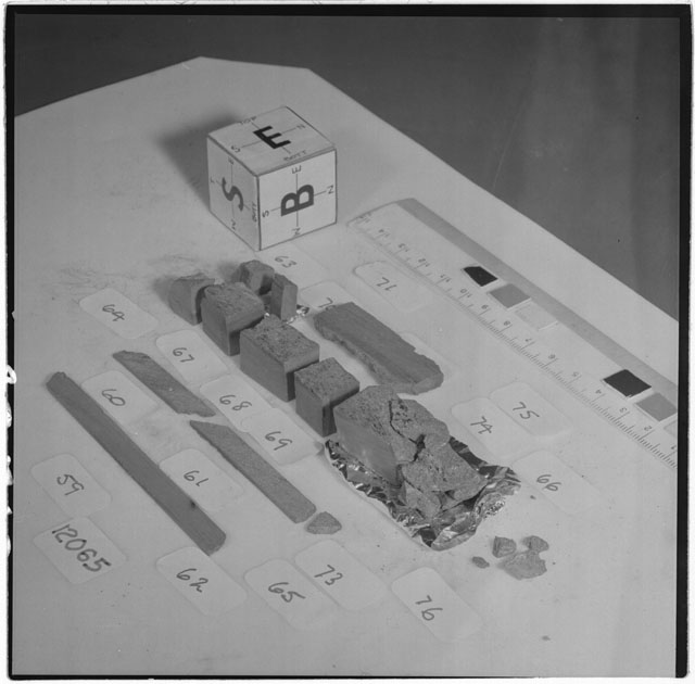 Black and white photograph of Apollo 12 Sample(S) 12065,59-71,73-76; Processing photograph displaying a slab reconstruction sample with an orientation of E,S,B.