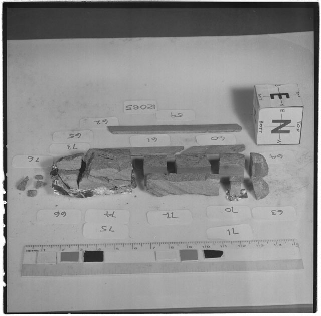 Black and white photograph of Apollo 12 Sample(S) 12065,59-71,73-76; Processing photograph displaying a slab reconstruction sample with an orientation of E,N .