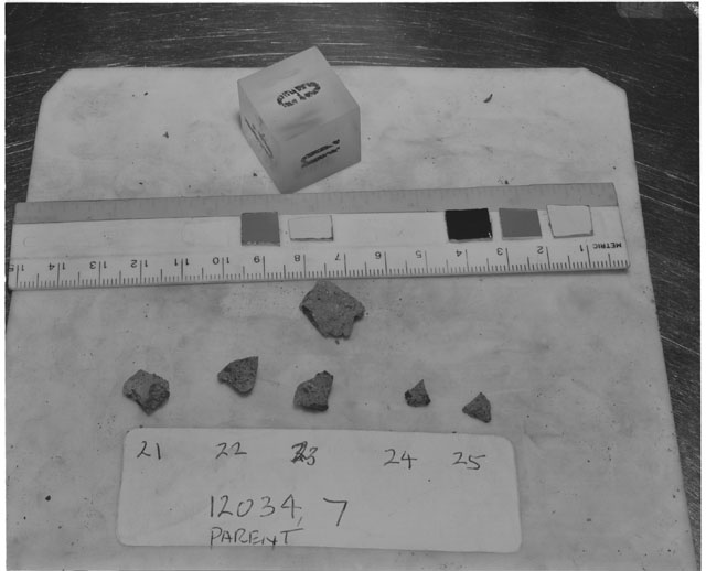 Black and white photograph of Apollo 12 Sample(S) 12034,7,21-25; Processing photograph displaying a post chip group with an orientation of E,B,N.