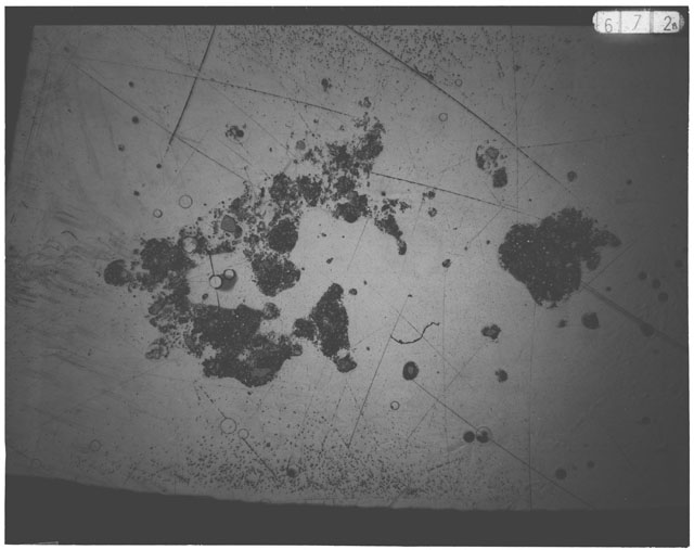 Black and white photograph of Apollo 12 sample 12030,26; Thin Section photograph displaying grain mount.