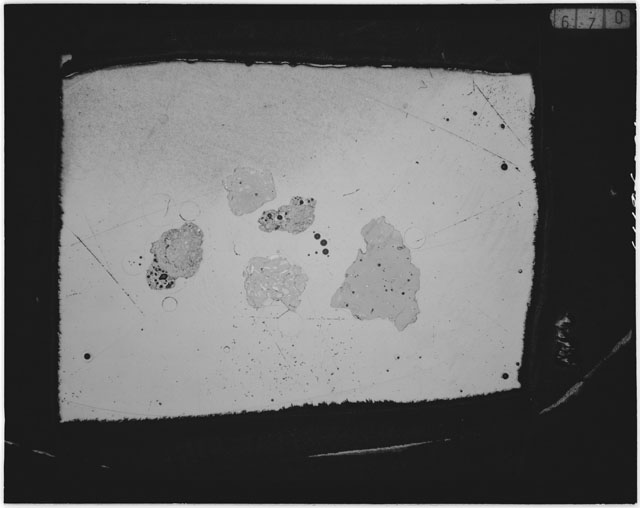 Black and white photograph of Apollo 12 sample 12044,29; Thin Section photograph displaying grain mount.