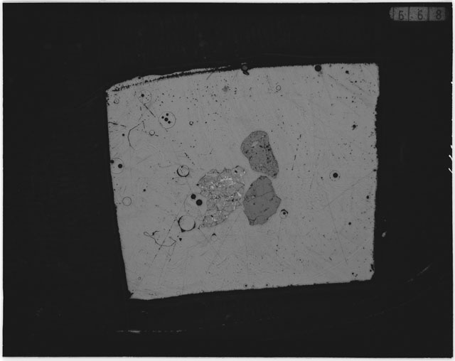 Black and white photograph of Apollo 12 sample 12044,32; Thin Section photograph displaying grain mount.
