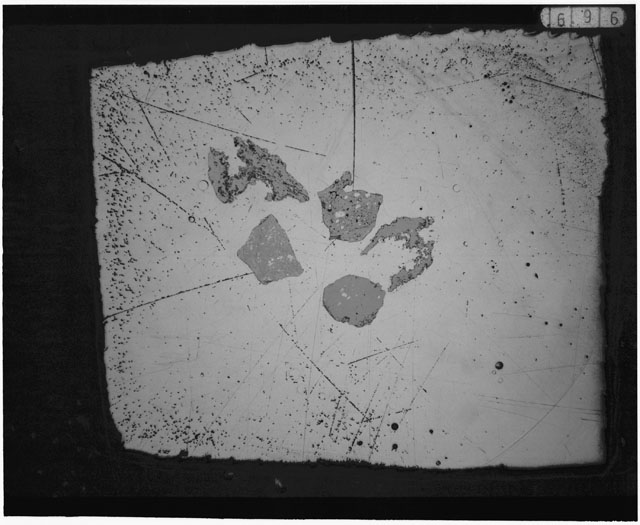 Black and white photograph of Apollo 12 sample 12033,83; Thin Section photograph displaying grain mount using transmitted light.