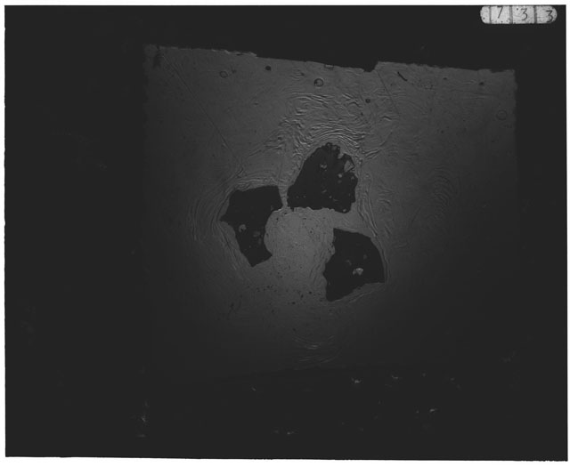 Black and white photograph of Apollo 12 sample 12033,82; Thin Section photograph displaying grain mount.