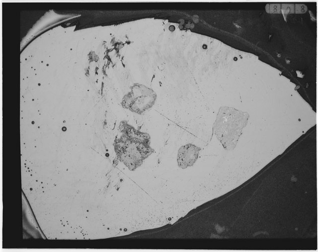 Black and white photograph of Apollo 12 sample 12033,86; Thin Section photograph displaying grain mount.
