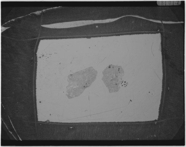 Black and white photograph of Apollo 12 sample 12030,22; Thin Section photograph displaying grain mount.
