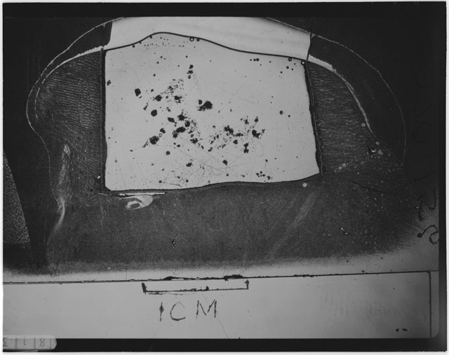 Black and white photograph of Apollo 12 sample 12070,156; Thin Section photograph displaying grain mount.
