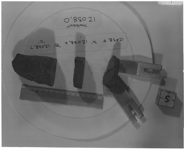 Black and white photograph of Apollo 12 Sample(S) 12038,5-7; Processing photograph displaying a post cut sample with an orientation of S.