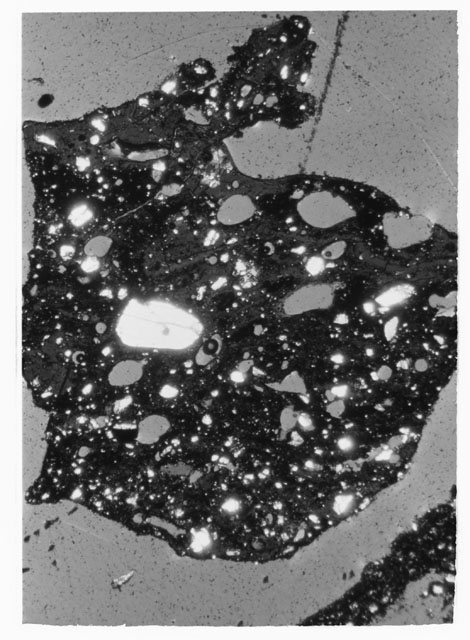 Black and white photograph of Apollo 12 sample 12033,83; Thin Section photograph displaying grain mount.