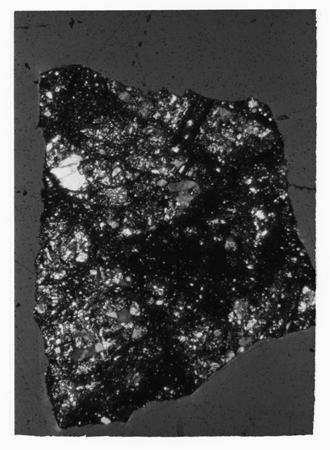 Black and white photograph of Apollo 12 sample 12033,83; Thin Section photograph displaying grain mount.