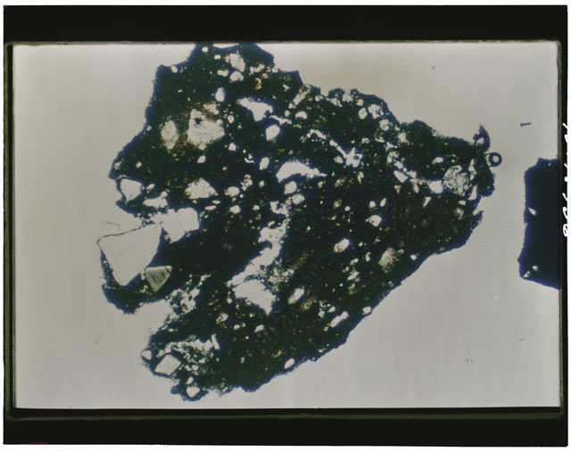 Color photograph of Apollo 12 sample 12033,82; Thin Section photograph displaying grain mount using cross nichols light.
