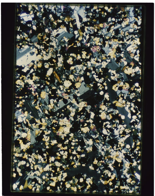 Color photograph of Apollo 11 Sample(s) 10017,61; Thin Section G photograph using cross nichols light.