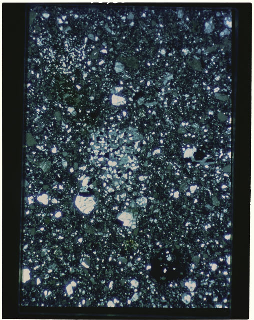 Color photograph of Apollo 11 Sample(s) 10019; Thin Section B photograph using transmitted light.