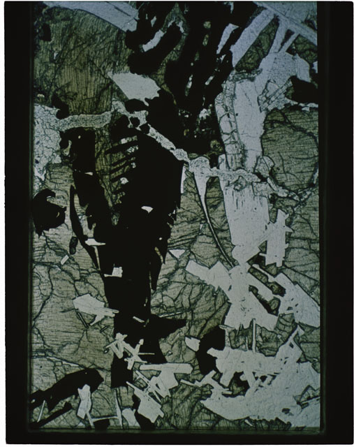 Color photograph of Apollo 11 Sample(s) 10044; Thin Section C' photograph using transmitted light.