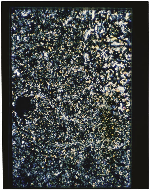 Color photograph of Apollo 11 Sample(s) 10069; Thin Section B photograph using cross nichols light.