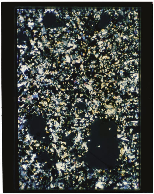 Color photograph of Apollo 11 Sample(s) 10069; Thin Section C photograph using cross nichols light.