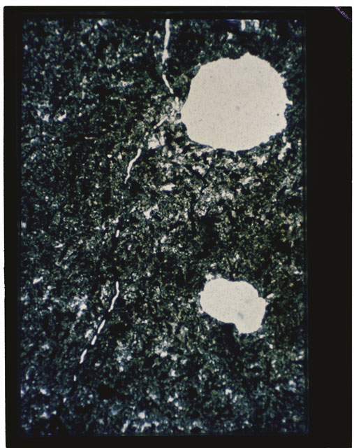 Color photograph of Apollo 11 Sample(s) 10069; Thin Section D photograph using transmitted light.