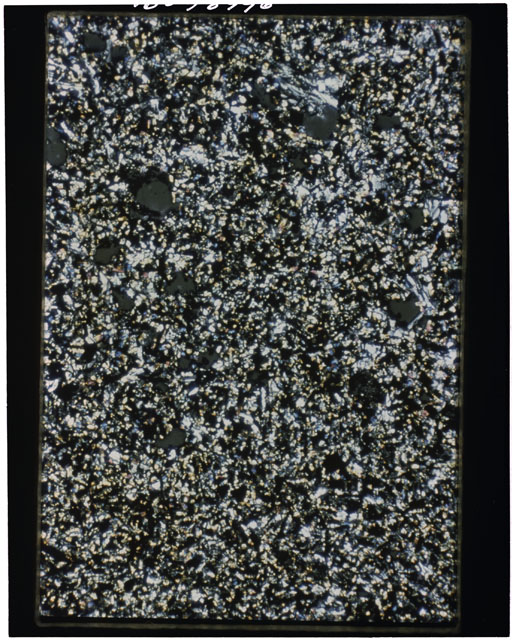 Color photograph of Apollo 11 Sample(s) 10049; Thin Section A photograph using cross nichols light.
