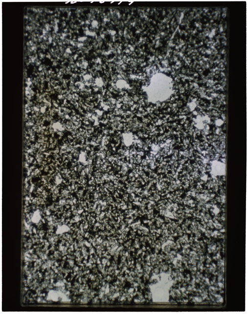 Color photograph of Apollo 11 Sample(s) 10049; Thin Section b photograph using transmitted light.