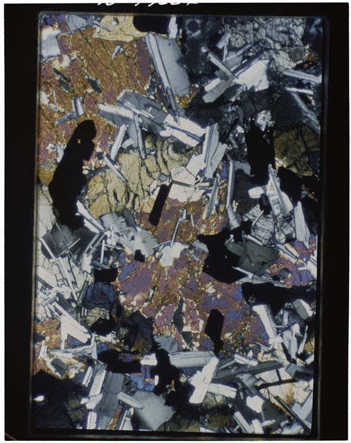 Color photograph of Apollo 11 Sample(s) 10050; Thin Section A photograph using cross nichols light.