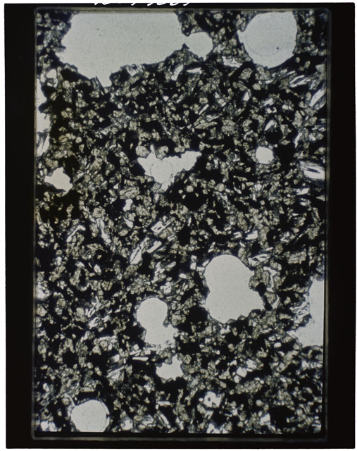 Color photograph of Apollo 11 Sample(s) 10057; Thin Section A photograph using transmitted light.