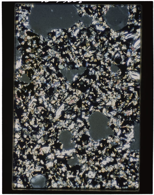 Color photograph of Apollo 11 Sample(s) 10057; Thin Section A photograph using cross nichols light.