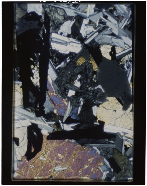 Color photograph of Apollo 11 Sample(s) 10058; Thin Section F photograph using cross nichols light.