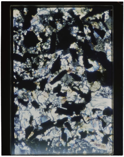 Color photograph of Apollo 11 Sample(s) 10069; Thin Section A photograph using cross nichols light.