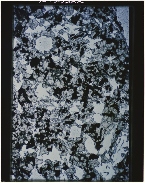 Color photograph of Apollo 11 Sample(s) 10017; Thin Section B photograph using transmitted light.