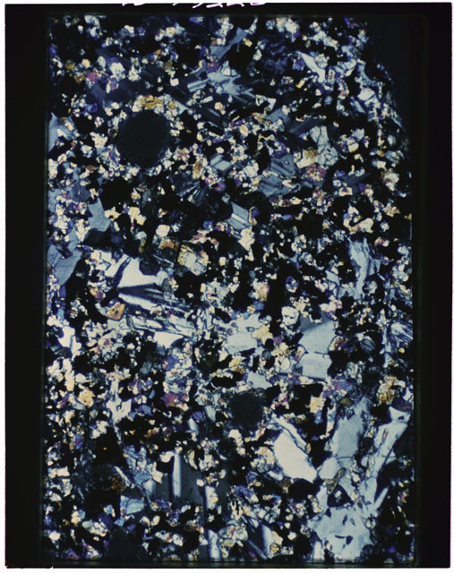 Color photograph of Apollo 11 Sample(s) 10017; Thin Section B photograph using cross nichols light.