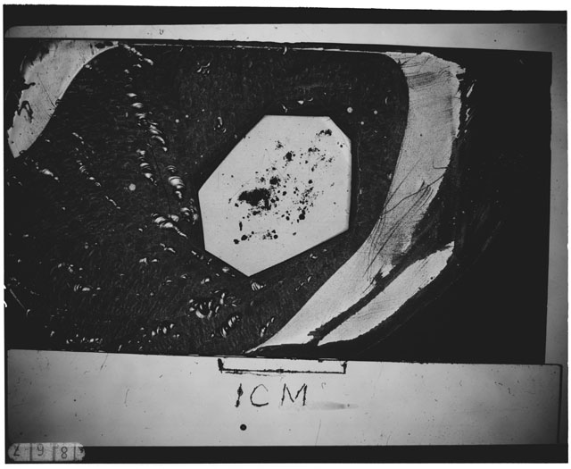 Black and white photograph of Apollo 12 sample 12044,36; Thin Section photograph displaying grain mount.