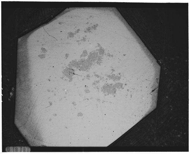 Black and white photograph of Apollo 12 sample 12044,35; Thin Section photograph displaying grain mount.