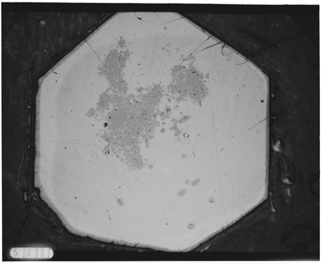 Black and white photograph of Apollo 12 sample 12044,38; Thin Section photograph displaying grain mount.