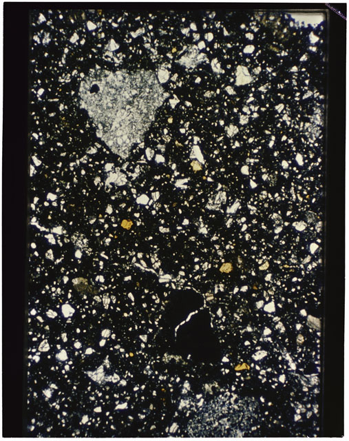 Color photograph of Apollo 11 Sample(s) 10021,28; Thin Section B using transmitted light.