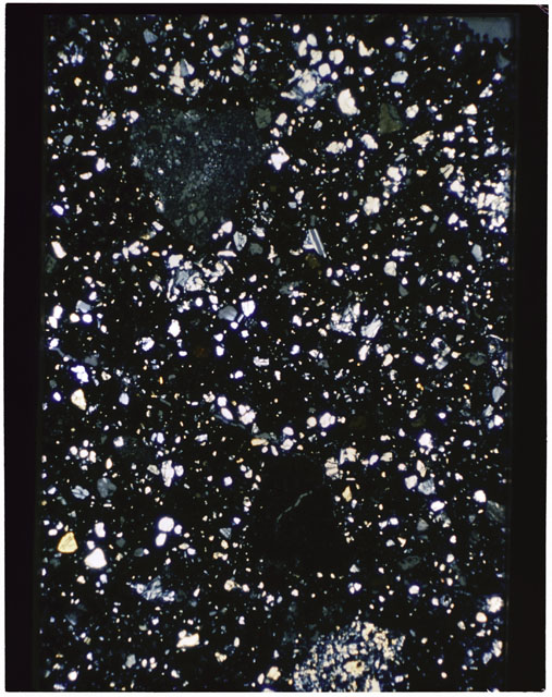 Color photograph of Apollo 11 Sample(s) 10021,28; Thin Section B using cross nichols light.