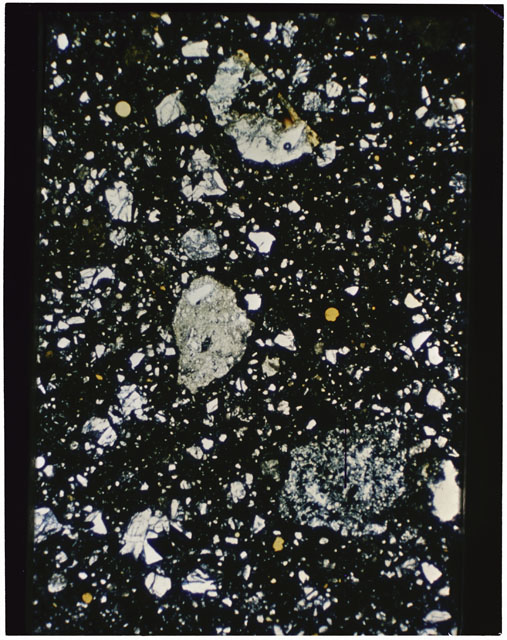 Color photograph of Apollo 11 Sample(s) 10021,28; Thin Section C using transmitted light.