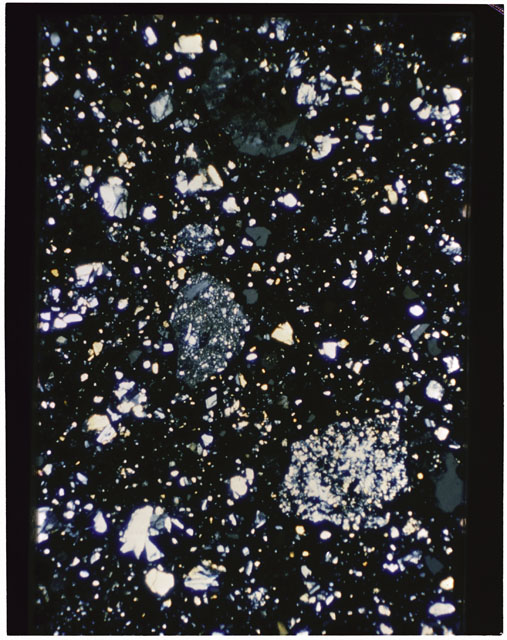 Color photograph of Apollo 11 Sample(s) 10021,28; Thin Section C using cross nichols light.