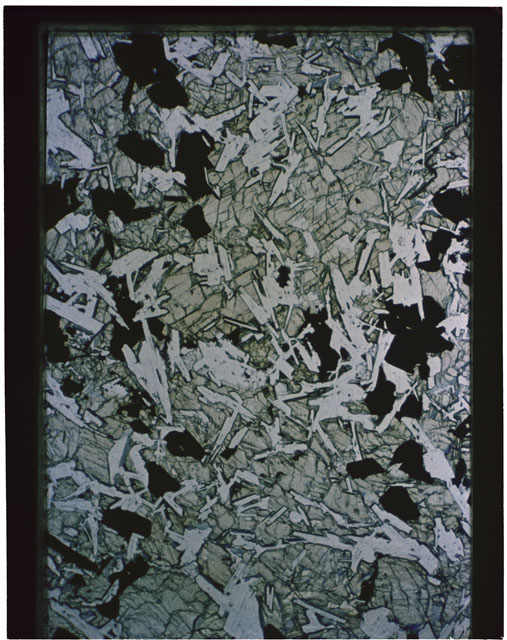 Color photograph of Apollo 11 Sample(s) 10003,37; Thin Section photograph using transmitted light.