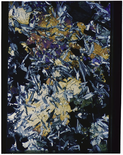 Color photograph of Apollo 11 Sample(s) 10003,37; Thin Section photograph using cross nichols light.