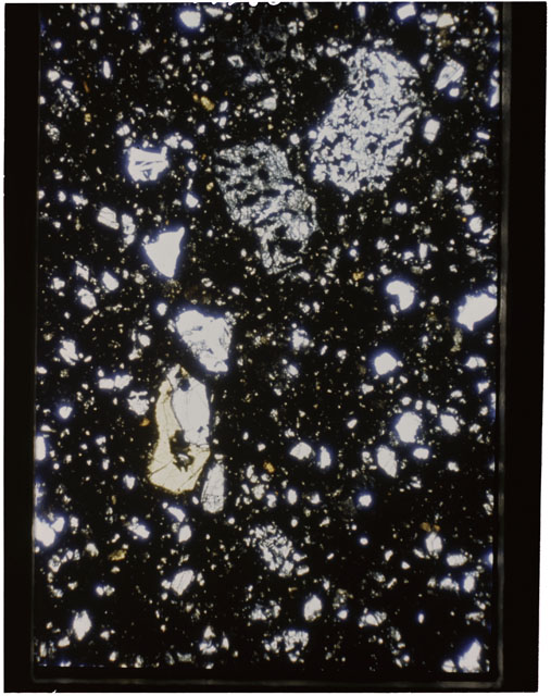 Color photograph of Apollo 11 Sample(s) 10021,30; Thin Section using transmitted light.