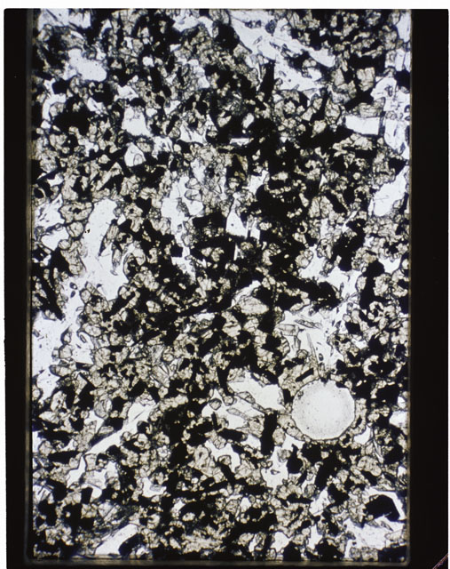 Color photograph of Apollo 11 Sample(s) 10017,15; Thin Section photograph using transmitted light.