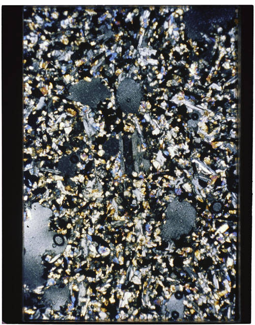 Color photograph of Apollo 11 Sample(s) 10057,77; Thin Section photograph using cross nichols light.