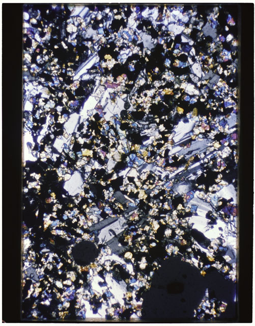 Color photograph of Apollo 11 Sample(s) 10017,62; Thin Section photograph using cross nichols light.