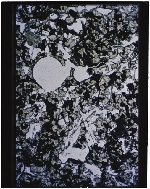 Color photograph of Apollo 11 Sample(s) 10017; Thin Section A photograph using transmitted light.