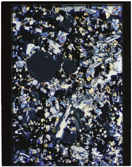 Color photograph of Apollo 11 Sample(s) 10017; Thin Section A photograph using cross nichols light.