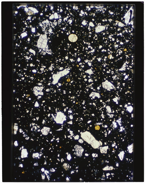 Color photograph of Apollo 11 Sample(s) 10019; Thin Section C photograph using cross nichols light.