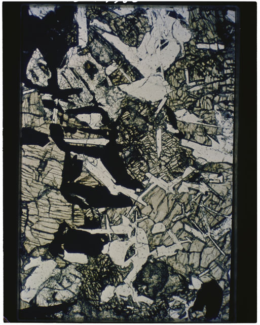Color photograph of Apollo 11 Sample(s) 10044; Thin Section H photograph using transmitted light.